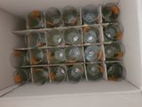 many empty bottles in a white box on the floor