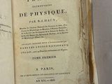 an old book that is open on a table