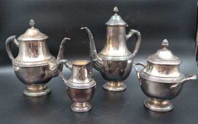 three silver teapots and two silver cups on a table