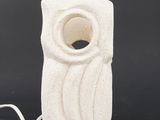 a white ceramic sculpture with a hole in the middle of it