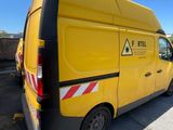 a yellow van that is parked in a parking lot