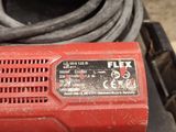 a close up of a red electric tool on a table