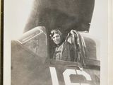 black and white photograph of a man sitting in the cockpit of a plane