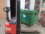 a fork lift truck parked in a garage with other boxes