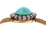 a close up of a ring with a turquoise stone on it