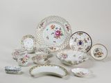 many different types of plates and bowls on the table