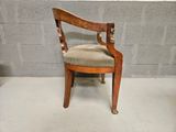 a wooden chair with a beige upholstered seat
