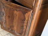 a wooden cabinet with a drawer on top of it
