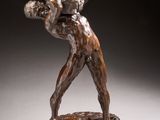 an image of a bronze statue of a man holding a basket