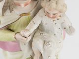 a figurine of a woman holding a baby