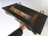 a man that is holding a wooden shelf in his hand