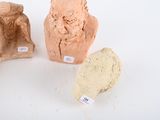 three clay vases sitting next to each other on a white surface