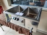 a stainless steel sink with a brown cloth on it