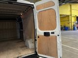 a white van with a wooden door open in a warehouse