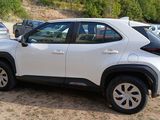 a white toyota rav parked on the side of the road