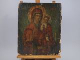 an old painting of a woman holding a child on a easel