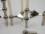 four candles that are sitting on a white table