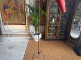 a lamp that is on a tripod stand in a room