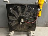 a large fan sitting on top of a metal stand in a garage