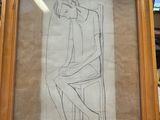 dessin encadré représentant une femme assise sur une chaise dans un magasin