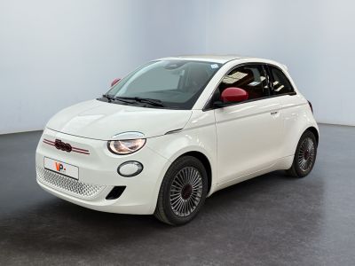 the small white car is parked in a room with a black floor
