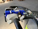 a close up of a blue and black handle on a motorcycle