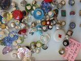 a lot of buttons on a table with a note