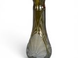 a green glass vase with a design on it