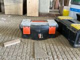 two black and orange tool boxes sitting on the floor