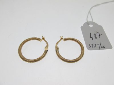 a pair of gold hoop earrings