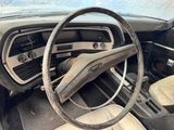 dashboard of an old car with a steering wheel and dashboard knobs