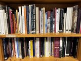 a book shelf with many books on it in a room