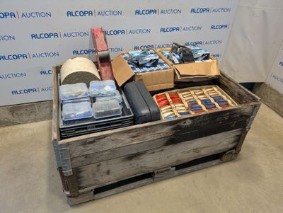 a wooden box filled with assorted items in front of a wall