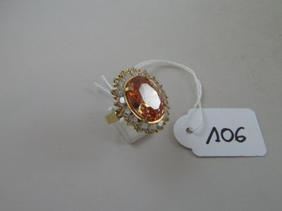 an image of a ring with a large orange stone surrounded by small white diamonds