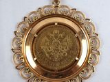 an image of a gold plate with a coin in the center