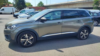 the grey car is parked in the parking lot near other cars