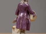 a figurine of a woman sitting on a tree stump