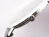 a close up of a watch on a white surface