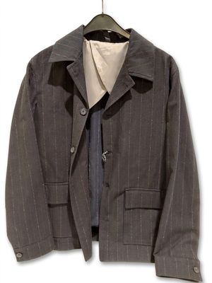 a suit jacket and tie hanging on a hanger