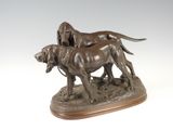statue of two dogs on a wooden base on a white background
