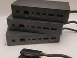 two black power cords are connected to a black power strip
