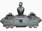 a statue of a man sitting on top of a table