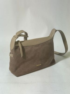 the small brown bag is sitting on a white surface
