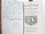 an old book with writing on it sitting on a table