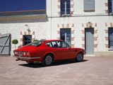 a red car parked in front of a white building