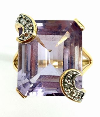 an image of a ring with a purple stone and a crescent