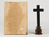 an old book with a cross on top of it next to a small wooden cross