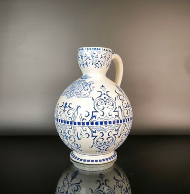 a blue and white vase sitting on a black table