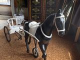 a toy horse pulling a carriage in a living room