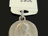 a close up of a silver medal with a tag on it